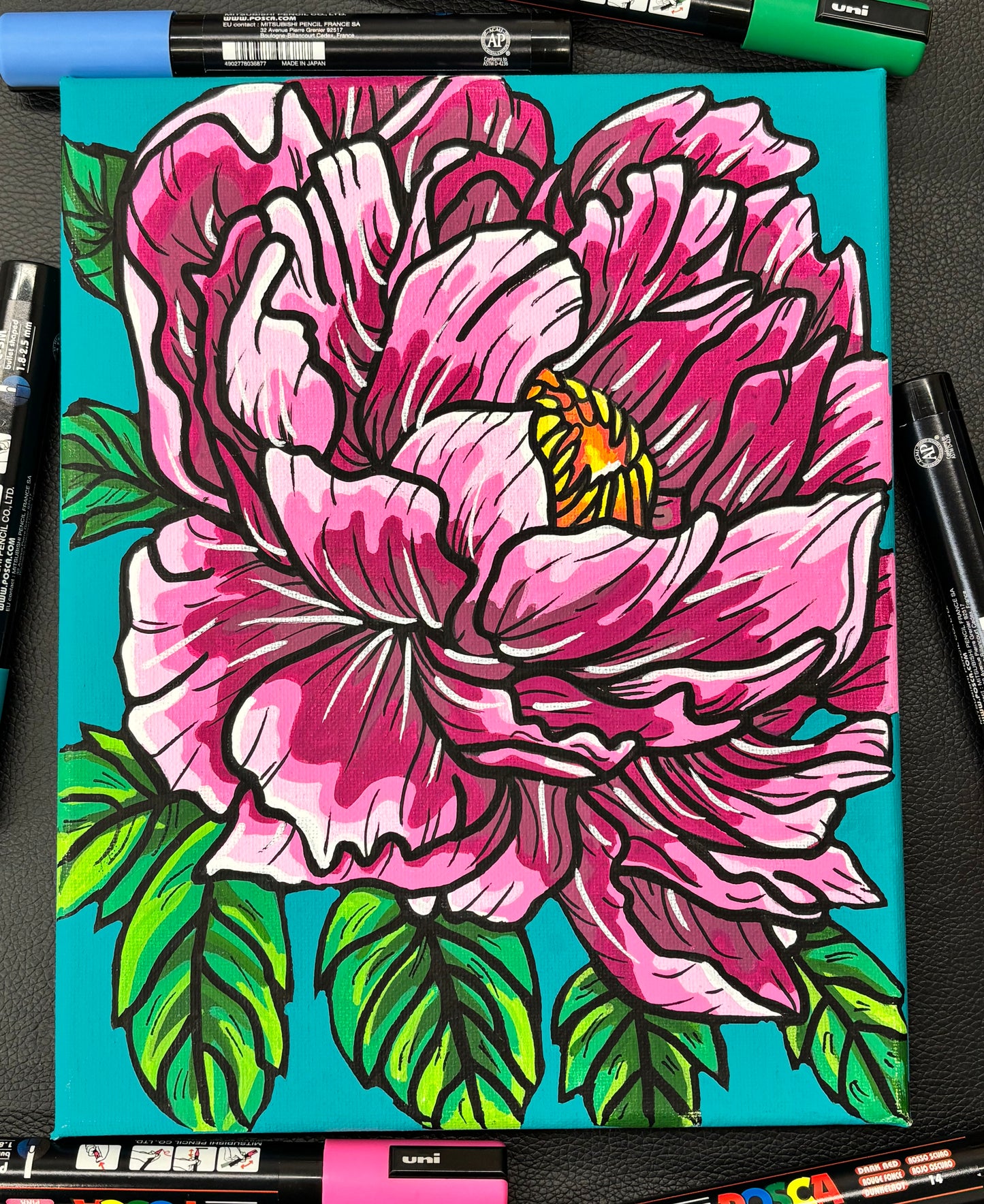 Colorful flower peony drawing on a blue background with markers around